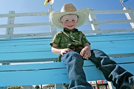 young boy in stands of county rodeo